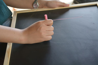 Close-up of woman hand holding book