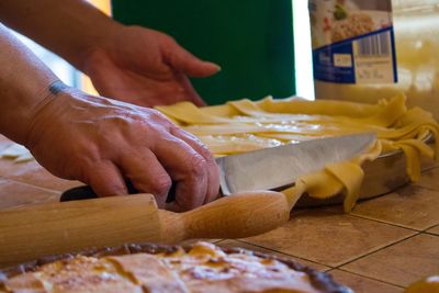 Cropped hands on person making pasta at home