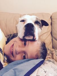 Portrait of boy with dog at home