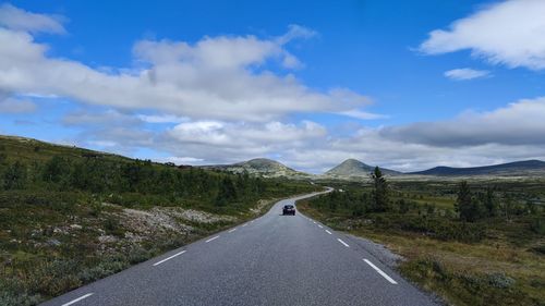 Road amidst landscape against sky