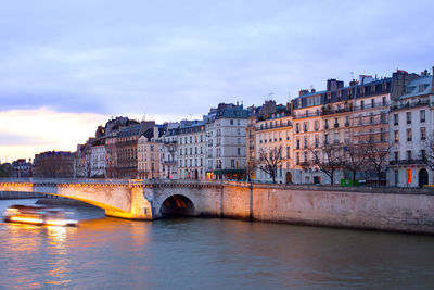 View of bridge over river against cloudy sky