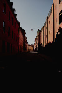 Street amidst buildings against clear sky
