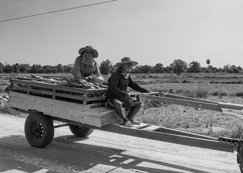 Man working on road against clear sky