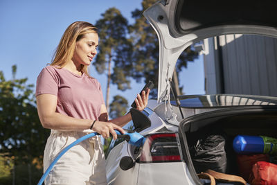 Man charging electric car