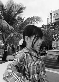 Portrait of smiling woman with palm tree