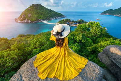 Rear view of person looking at sea against sky