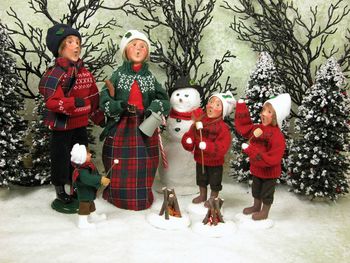 Full length of children on snow covered tree