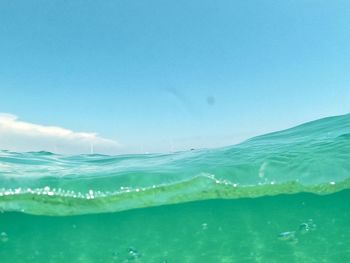 Wave in sea against blue sky