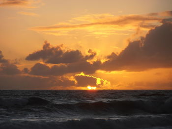 Scenic view of beach against sky during sunset