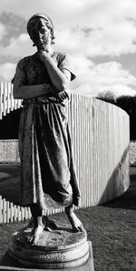 Woman standing against cloudy sky