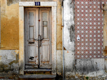 Closed door of old building with tiled wall. lisbon portugal