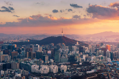 Aerial view of cityscape against sky during sunset