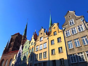 Low angle view of buildings against blue sky