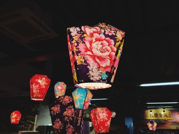Illuminated lanterns hanging in shop