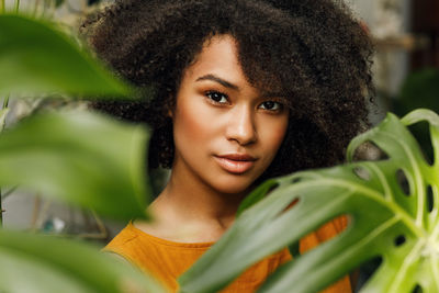 Portrait of teenage girl by plants