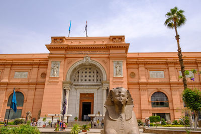 Low angle view of statues on building against sky