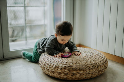 Cute boy playing with toy at home