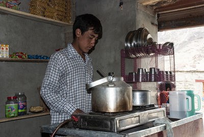 Portrait of a young boy of his tea stall.