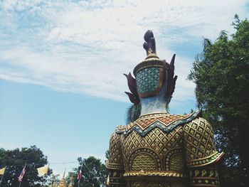 Low angle view of statue against trees and sky