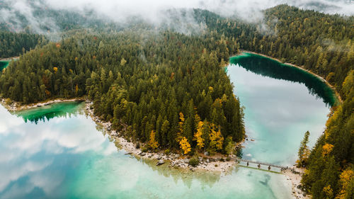 Autumn in the bavarian mountains, germany. landscape with lake, bridge, from above. drone photo.