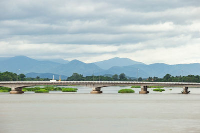Scenic view of bridge over river against sky