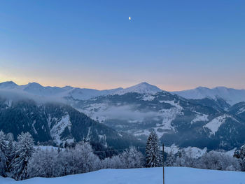 Scenic view of snow covered mountains against sky