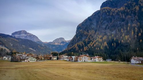 Scenic view of houses and mountains against sky