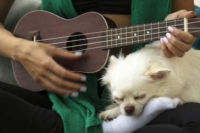 Midsection of man playing guitar