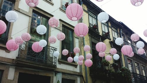 Low angle view of lanterns hanging against building