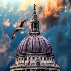 Low angle view of building against cloudy sky
