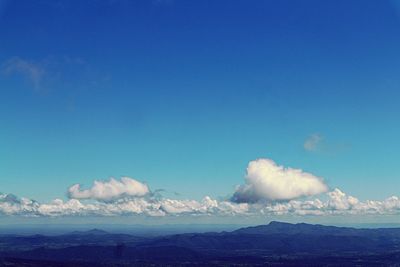 Scenic view of mountains against blue sky