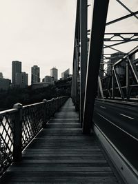 Footbridge against buildings in city