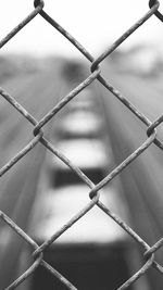 Close-up of chainlink fence against sky