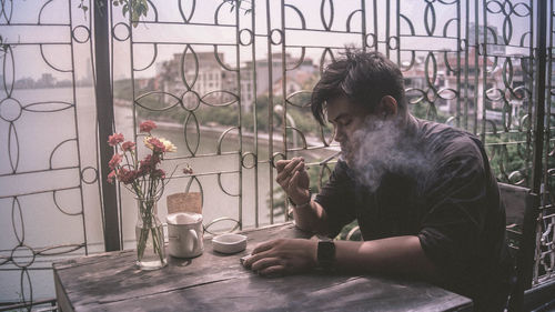 Portrait of man smoking at cafe