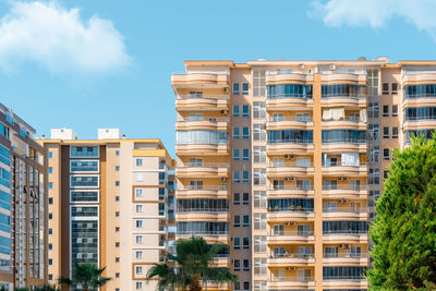 Fragments of the facades of modern multi-storey residential buildings, front view.