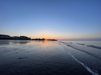 Scenic view of sea against clear sky during sunset