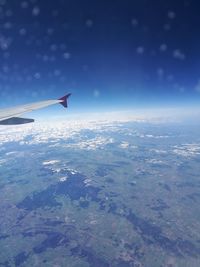 Airplane flying over sea against sky