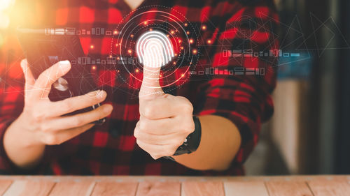 Close-up of woman holding illuminated lighting equipment