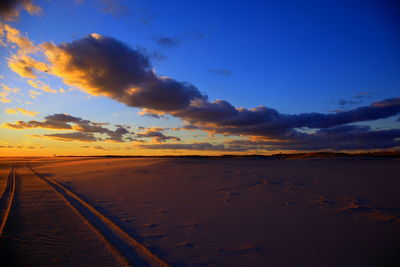 Scenic view of beach against sky during sunset