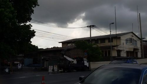 Power lines against cloudy sky