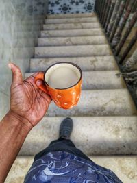 Midsection of man holding coffee