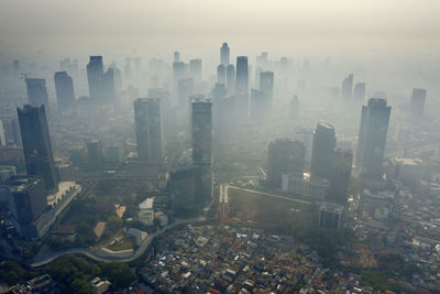 High angle view of modern buildings in city against sky