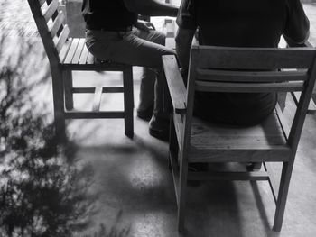 Low section of man sitting on chair