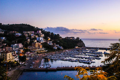 High angle view of buildings by sea against sky