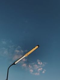 Low angle view of crane against blue sky