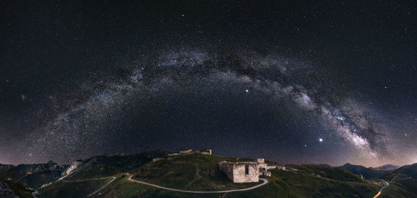 Scenic view of mountains against sky at night