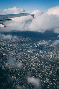 Aerial view of airplane flying over city