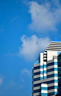 Low angle view of modern building against blue sky