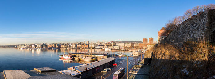 High angle view of buildings by sea against sky