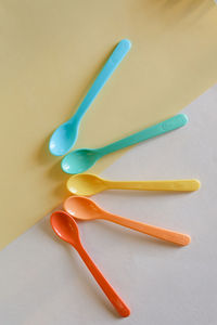 High angle view of chopsticks over yellow background